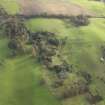 Oblique aerial view centred on the remains of the country house, taken from the WNW.