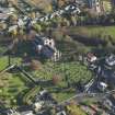 Oblique aerial view centred on the church with the grayeyard adjacent, taken from the NW.