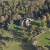 Oblique aerial view centred on the tower house/country house, taken from the W.