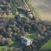 Oblique aerial view centred on the country house with the stable block adjacent, taken from the NW.