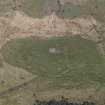 Oblique aerial view of the remains of the field-systems and cairn at Drumwhirn, taken from the SW.