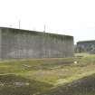 View from NW of W elelvation of magazine showing shuttered concrete blast wall.