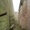 Detail of space between the shuttered concrete blast wall and the brick magazine.