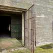 Detail of entrance through the shuttered concrete blast wall with the personnel entrance.