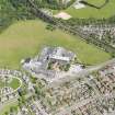 Oblique aerial view centred on Mackie Academy in Stonehaven, taken from the W.