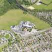 Oblique aerial view centred on Mackie Academy in Stonehaven, taken from the W.