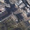 Oblique aerial view centred on the church with the hotel adjacent, taken from the SE.