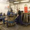 Interior view of Cask Rebuild Process, Dundashill Cooperage, Glasgow. Jamie O' Hare, a cooper for 41 years, building or 'rising' a cask. To his right, the unpacked ex-bourbon barrel oak staves bought in from the USA. Cask shell build nearing completion. The windlass has been applied and is about to be tightened.