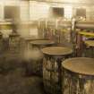Interior.  Cask Rebuild Process. Steam Pans 1 and 2 (background). Steaming causes the cask shell to swell up and force the oak staves. If a cask was kept dry during building it would not be watertight.