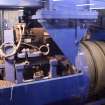 Interior.  Cask Rebuild Process. Croze Machine. A chapped out cask shell with its four temporary truss hoops having its chimes trimmed and grooves cut.