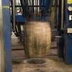 Interior. Cask Rebuilding and Rejuvination Process. Vertical Cask Hoop Driving Machine. First Cask Hoop Drive. The cask has just been turned 180 degrees. One set of end or chime, quarter and bilge hoops have been tightened and the process is to be repeated at the other end of the cask. The cask is still warm from charring (rejuvination) or steaming (rebuild) at this point.