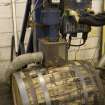 Interior. Cask Rebuilding Process. Bung Hole Borer. The bung hole being bored after the frist hoop drive.This machine has an extractor to remove the wood dust and shavings. The cask is still warm from charring (rejuvination) or steaming (rebuild) at this point. This drilling machine has an extractor to remove the wood dust and shavings.