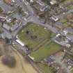 Oblique aerial view centred on the graveyard, taken from the ESE.