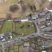 Oblique aerial view centred on the graveyard, taken from the NNW.