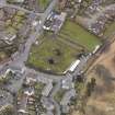 Oblique aerial view centred on the graveyard, taken from the SW.