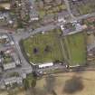 Oblique aerial view centred on the graveyard, taken from the S.