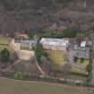 Oblique aerial view centred on the house with the college adjacent, taken from the SE.