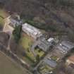Oblique aerial view centred on the house with the college adjacent, taken from the SE.