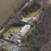 Oblique aerial view centred on the house with the college adjacent, taken from the NE.