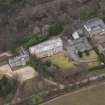 Oblique aerial view centred on the house with the college adjacent, taken from the S.
