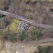 Oblique aerial view centred on the house with the road bridge adjacent, taken from the SE.