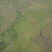 Oblique aerial view of the remains of the buildings and field banks, taken from the SW.