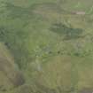 Oblique aerial view of the remains of the buildings and field banks, taken from the S.