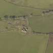 Oblique aerial view centred on the remains of the farmstead, taken from the E.