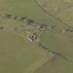 Oblique aerial view centred on the remains of the farmstead, taken from the NE.