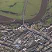 Oblique aerial view centred on the High Street with the Bridge of Annan adjacent, taken from the SE.