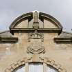 Detail of broken pediment and coat of arms on pool hall of Clydebank public baths and swimming pool.