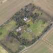 Oblique aerial view centred on the country house with the  walled garden, gate-lodges and cottage adjacent, taken from the SW.