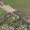 Oblique aerial view centred on the church with the tithe barn adjacent, taken from the SE.