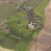 Oblique aerial view centred on the country house with the Home Farm adjacent,  taken from the SE.