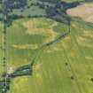 Oblique aerial view of the cropmarks of the round houses, taken from the NNW.