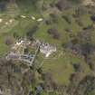 Oblique aerial view centred on the hotel with the stable block adjacent, taken from the S.