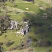 Oblique aerial view centred on the hotel with the stable block adjacent, taken from the E.