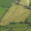 Oblique aerial view of the cropmarks of the unenclosed round houses and the barrow, taken from the S.