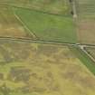 Oblique aerial view of the cropmarks of the barrow, taken from the NNE.