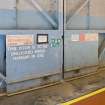 Interior.  detail of warning notices on main sliding (rolling) door of unprotected C type aircraft hangar (E).