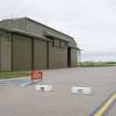 Detail of E door and gable end of unprotected C type hangar (E) with foreign object grid in the foreground.