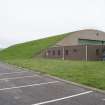 View from E showing grass covered concrete roof to L type aircraft hangar with Regional Non-destructive Testing Team offices in foreground in NW dispersal area.