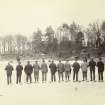 View of St Fort Curling Club on the ice with their backs to the camera.