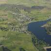 General oblique aerial view of Lairg with the power station, dam and crannog in the foreground, taken from the NW.