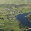General oblique aerial view of Lairg with the power station, dam and crannog in the foreground, taken from the NW.