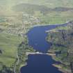 General oblique aerial view of Lairg with the power station, dam and crannog in the foreground, taken from the WNW.