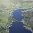 General oblique aerial view of Lairg with the power station, dam and crannog in the foreground, taken from the WNW.