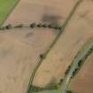 Oblique aerial view of the soilmarks of the W ditch of Newstead Roman fort, taken from the WSW.
