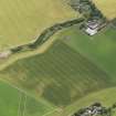 Oblique aerial view of the cropmarks of the unenclosed roundhouses at Anniston Mill, taken from the N.