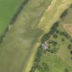Oblique aerial view of the cropmarks of the roundhouses at Anniston Cottages, taken from the SW.